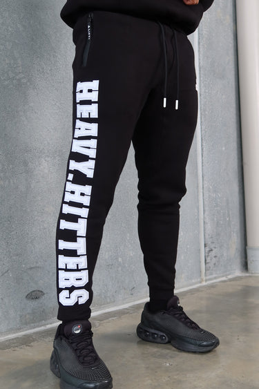 Donny Trackpants in black and white by Lift The Label, close up of chenille Heavy Hitters leg print