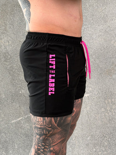 Della Squat Shorts in black and pink by Lift The Label, side view showing pink logo print