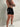 Della Squat Shorts in black and white, mens gym shorts by Lift The Label, side view with logo print